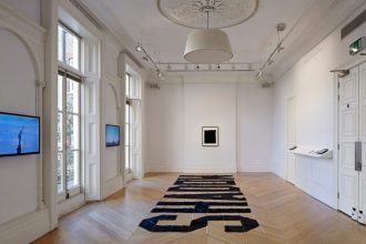 DAVID BIRKIN, Severe Clear, 2014. Aerial banner installation at The Mosaic Rooms in 2015. (Image courtesy of Andy Stagg.)