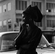 James Barnor, Margaret Obiri-Yeboah outside Sick-Hagemeyer’s shop, Accra, 1970-1971